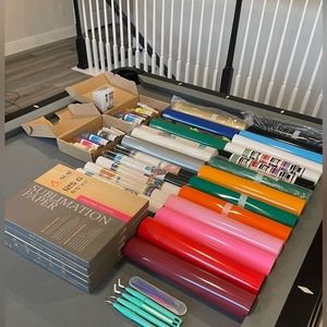 New and used rolls of heat transfer vinyl and sublimation paper.